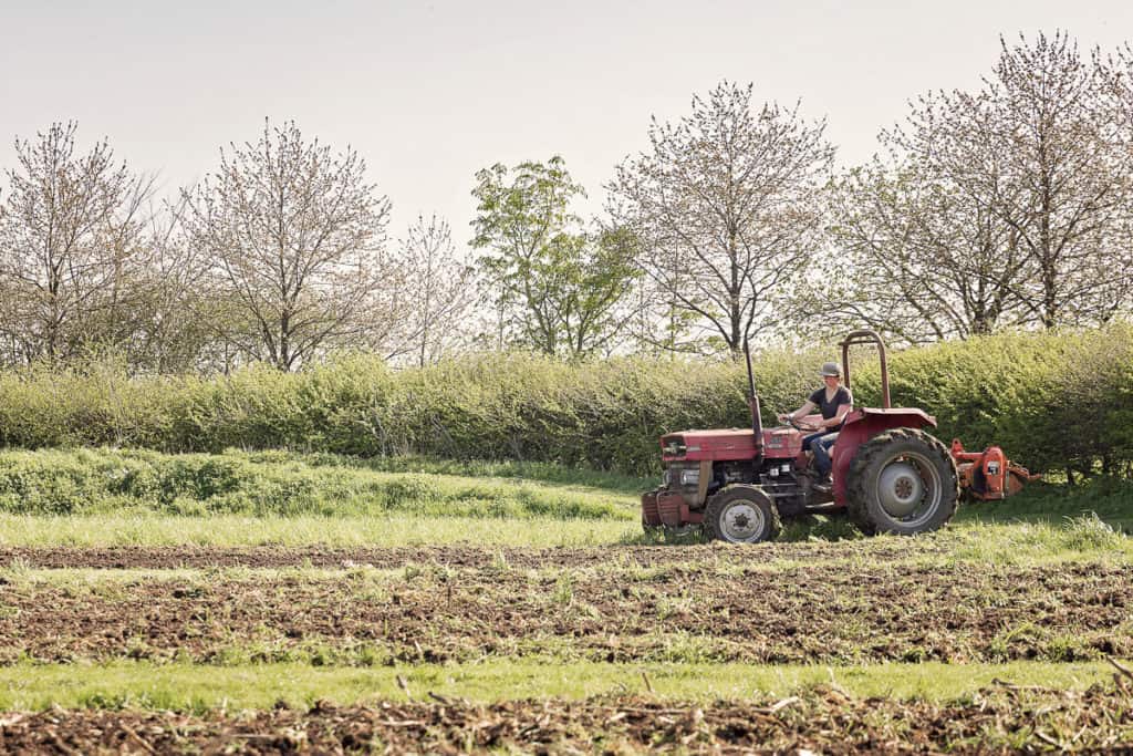 Tractor Ploughing the fields at Cambridgeshire Farm Wedding Venue