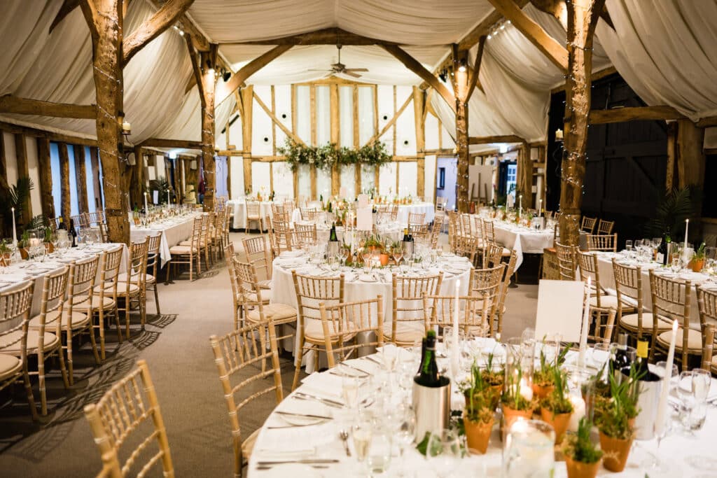 Wedding venue set for meal with winter greenery