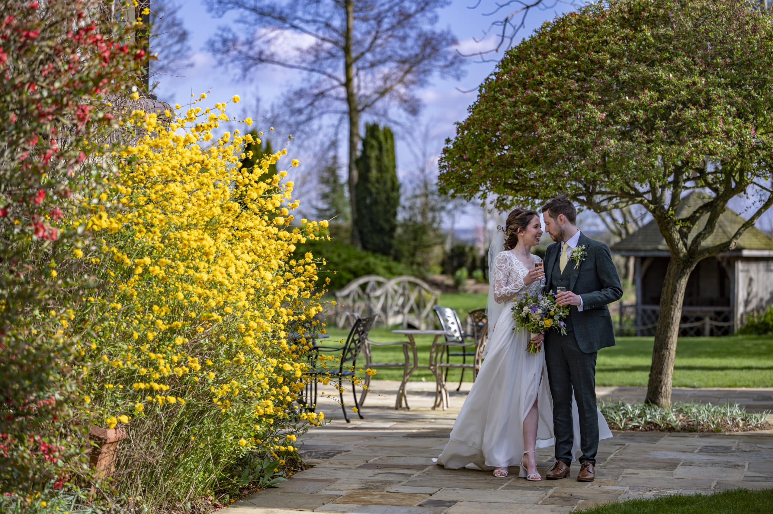 Bride and Groom on the Garden Terrace with Spring flowers