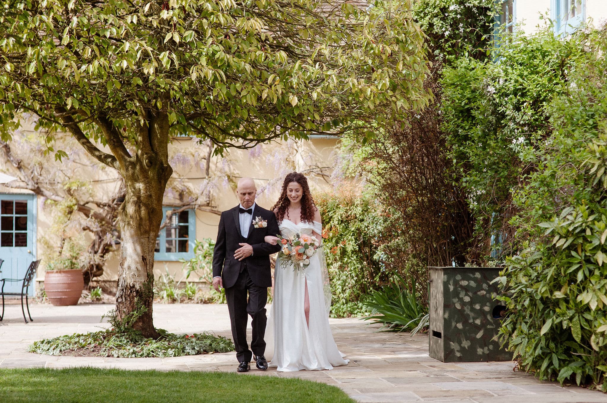 Bride and her father walking down the aisle to the Summerhouse at outdoor wedding venue