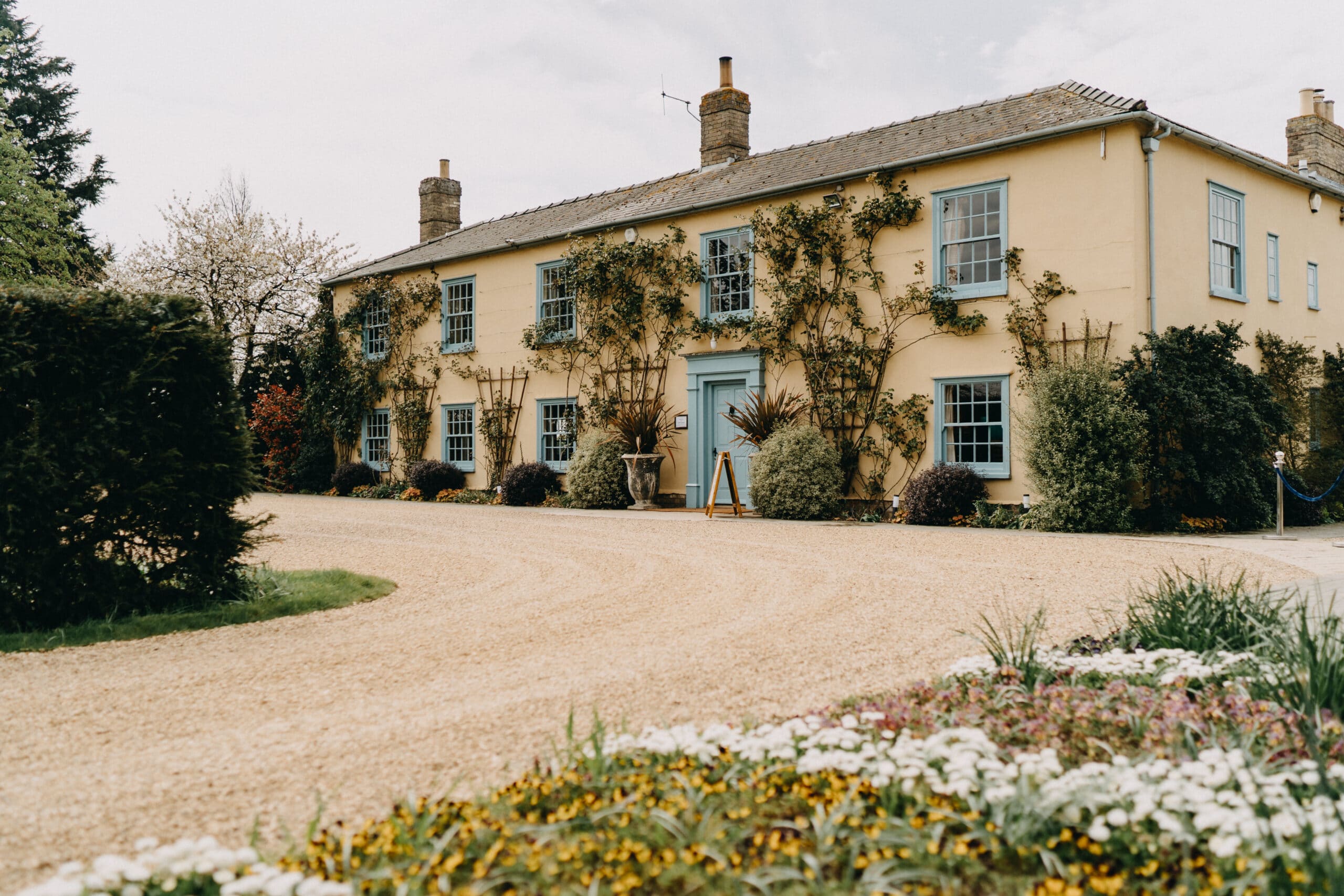 Charming South Farm farmhouse adorned with spring florals at barn style wedding venue
