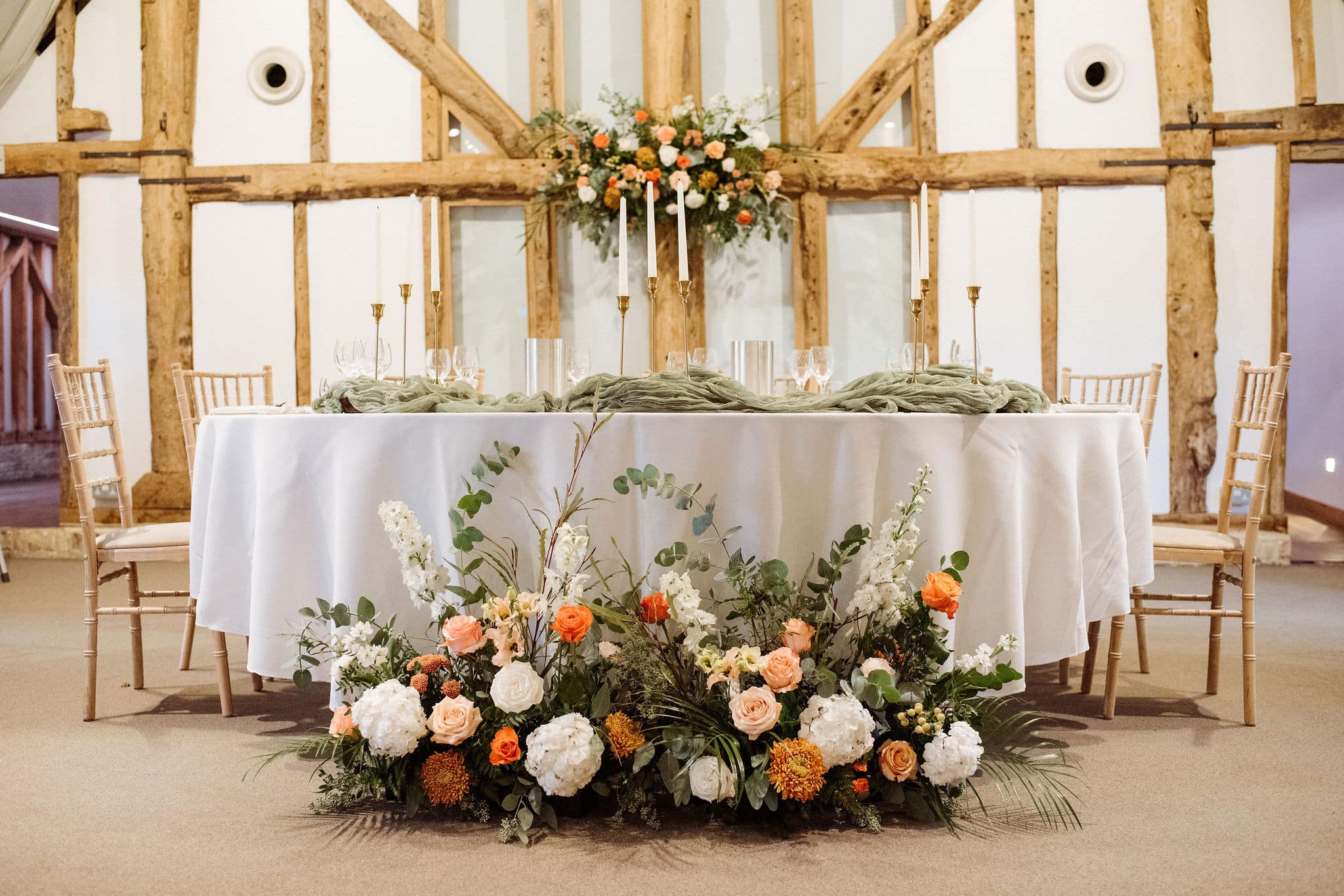Rustic Tudor Barn top table at countryside wedding venue with spring floral table set up