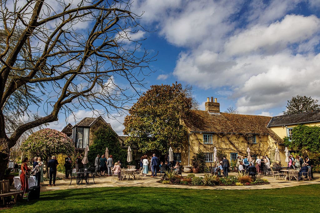 Garden wedding reception on sunny day at countryside farm house wedding veneu
