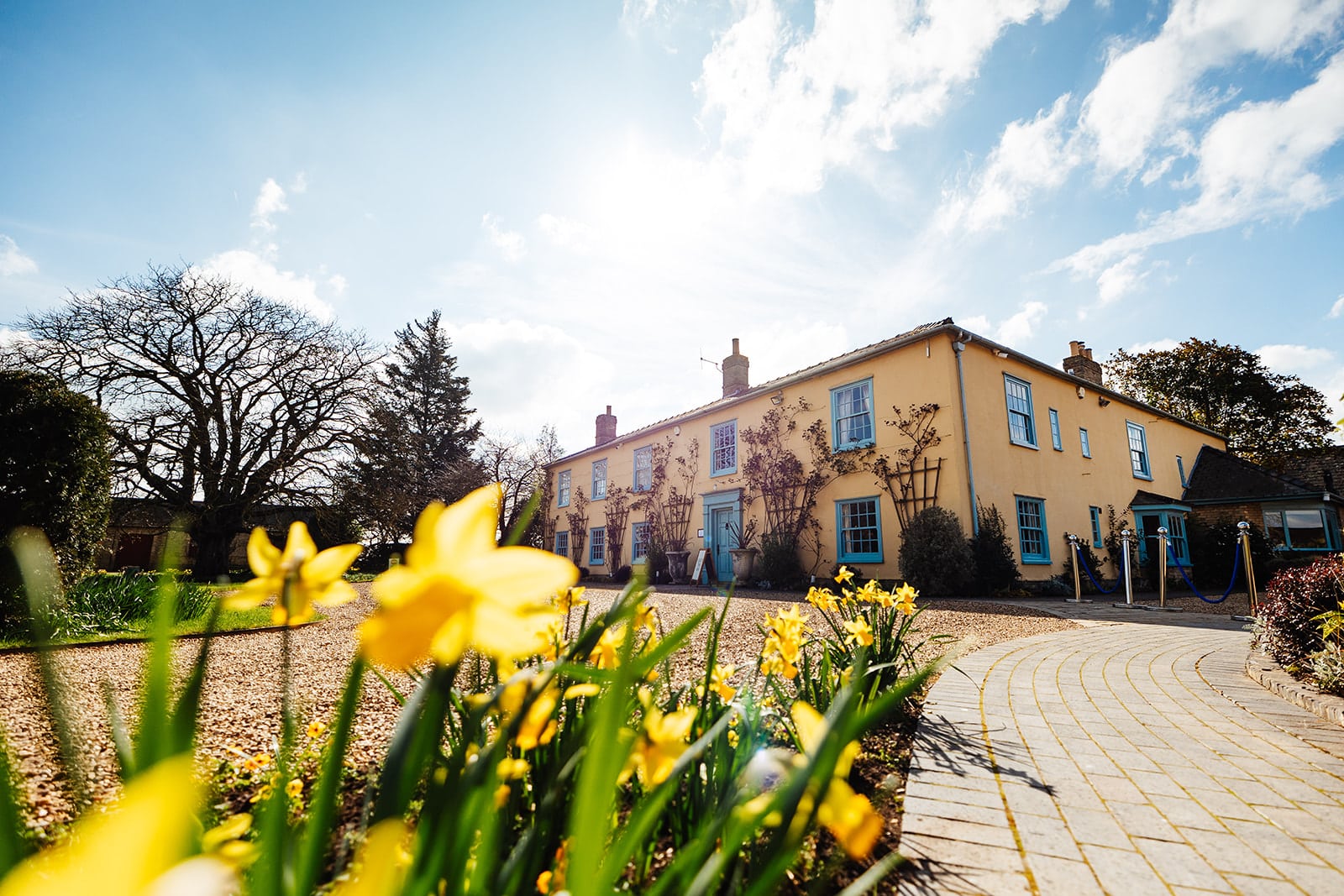 The South Farm Farmhouse with daffodils at the front barn wedding venue