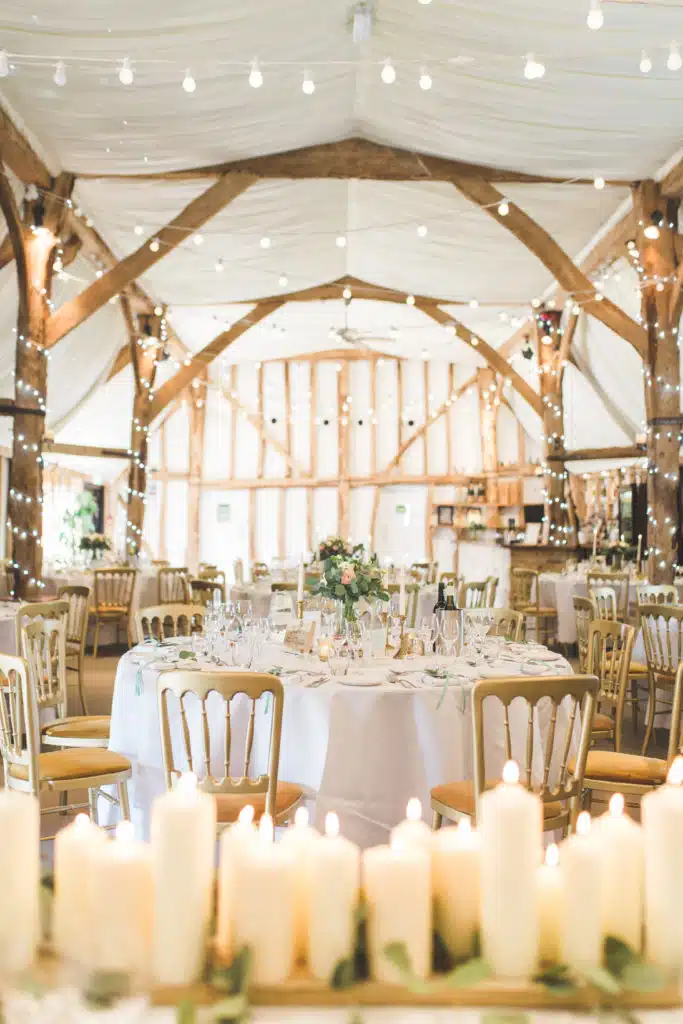 Tudor Barn at South Farm set for wedding meal with candles and looking pretty