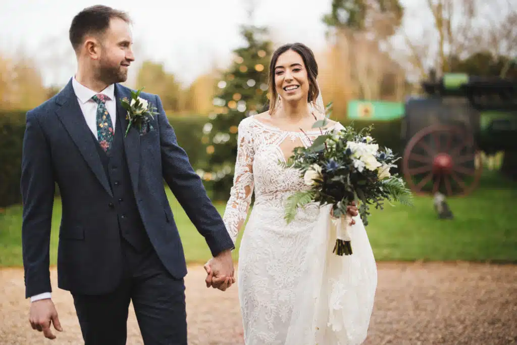 Bride and Groom in front of twinkly Christmas Tree at Winter Wedding Venue