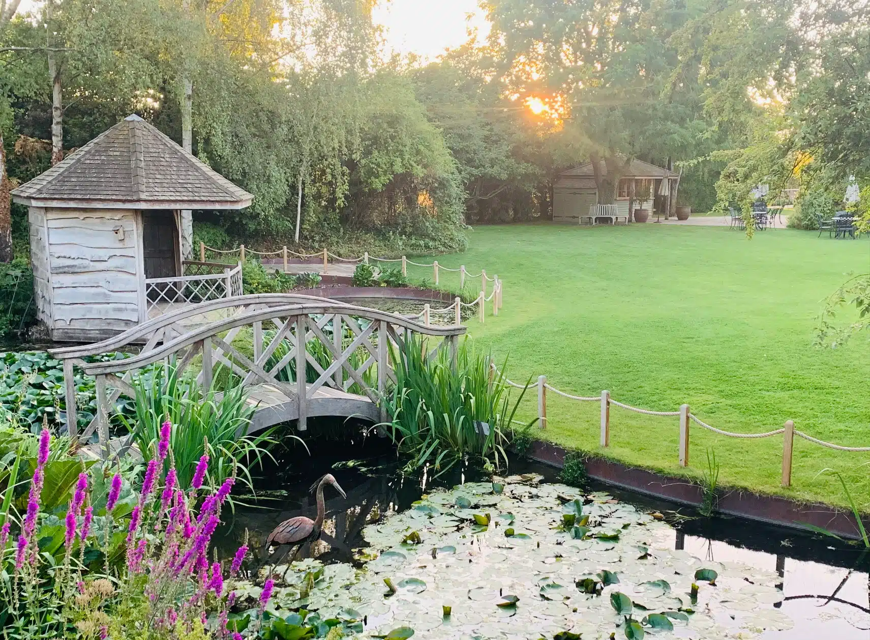 Rustic Summerhouse with bridge over pond at garden wedding venue