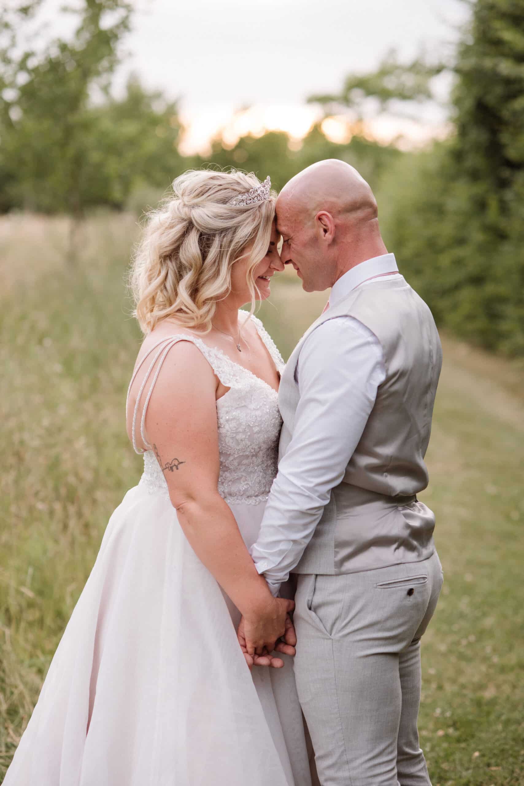 Bride and Groom share a special moment on their wedding day in countryside setting