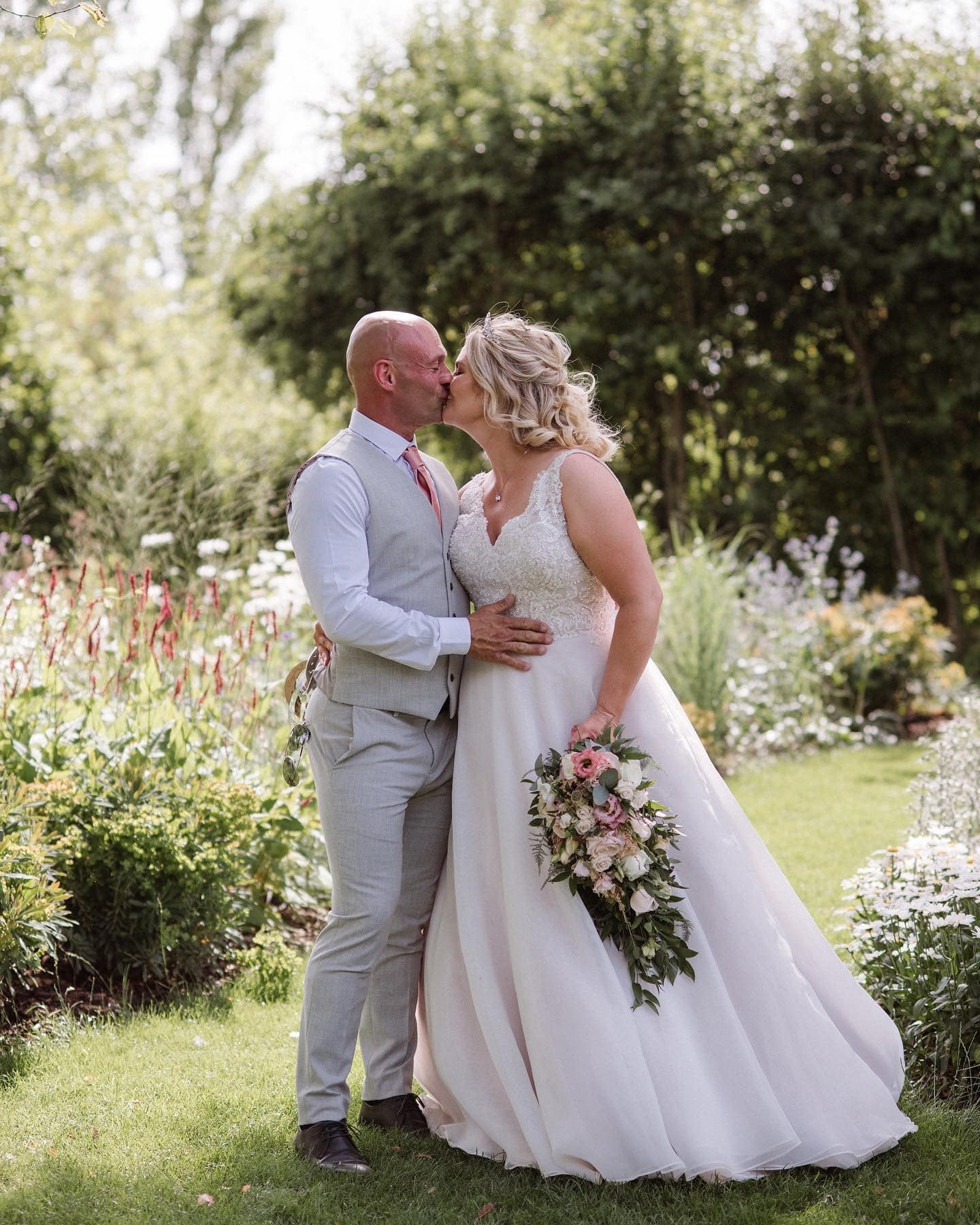 Bride and Groom Just married share a kiss in garden wedding venue 