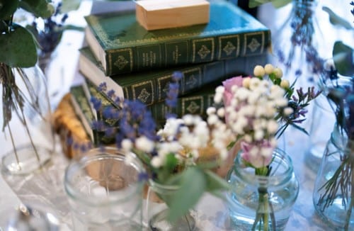 Vintage books and flowers as wedding table centrepieces rustic wedding venue 