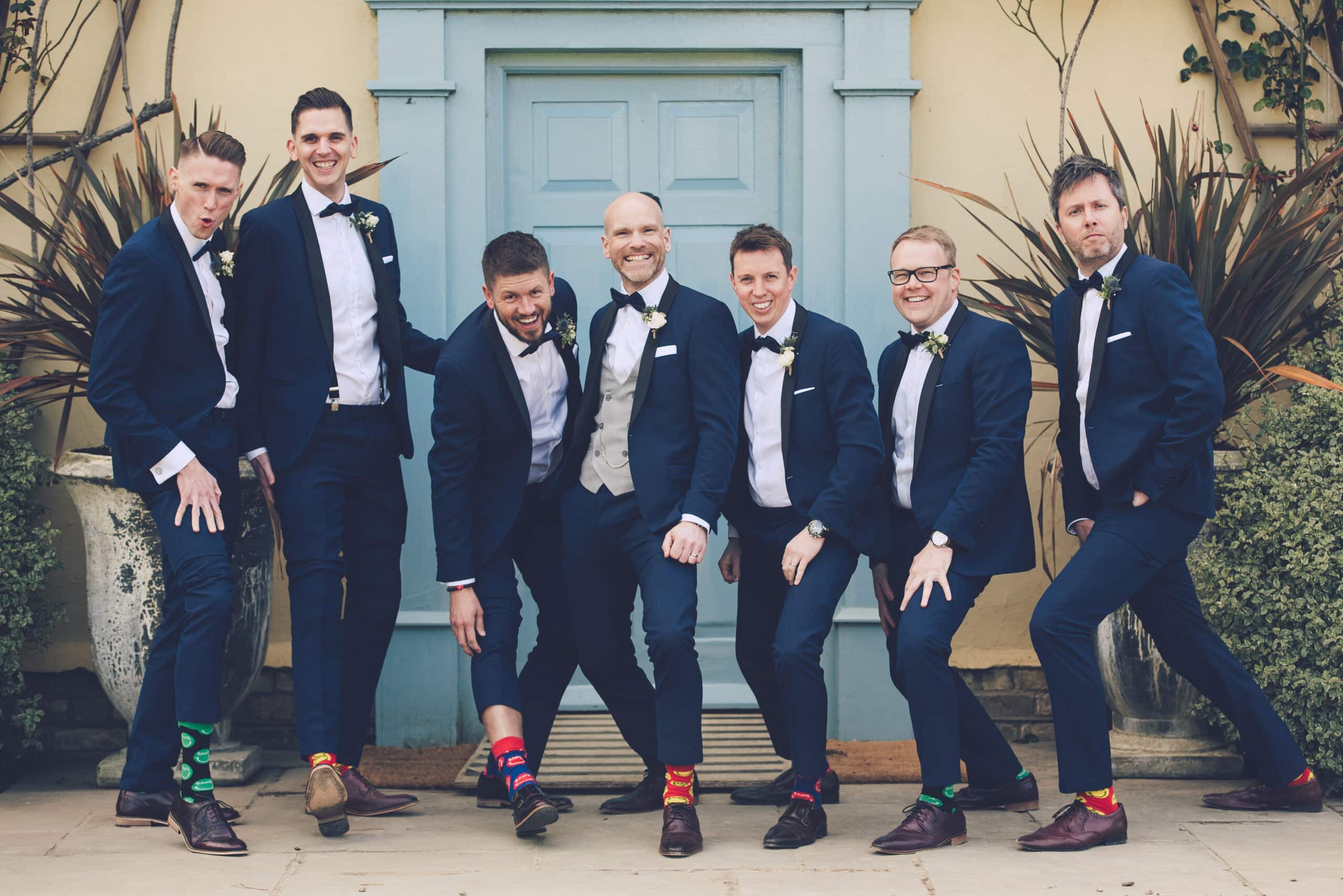 Groom and Groomsmen on wedding day show off colourful socks 