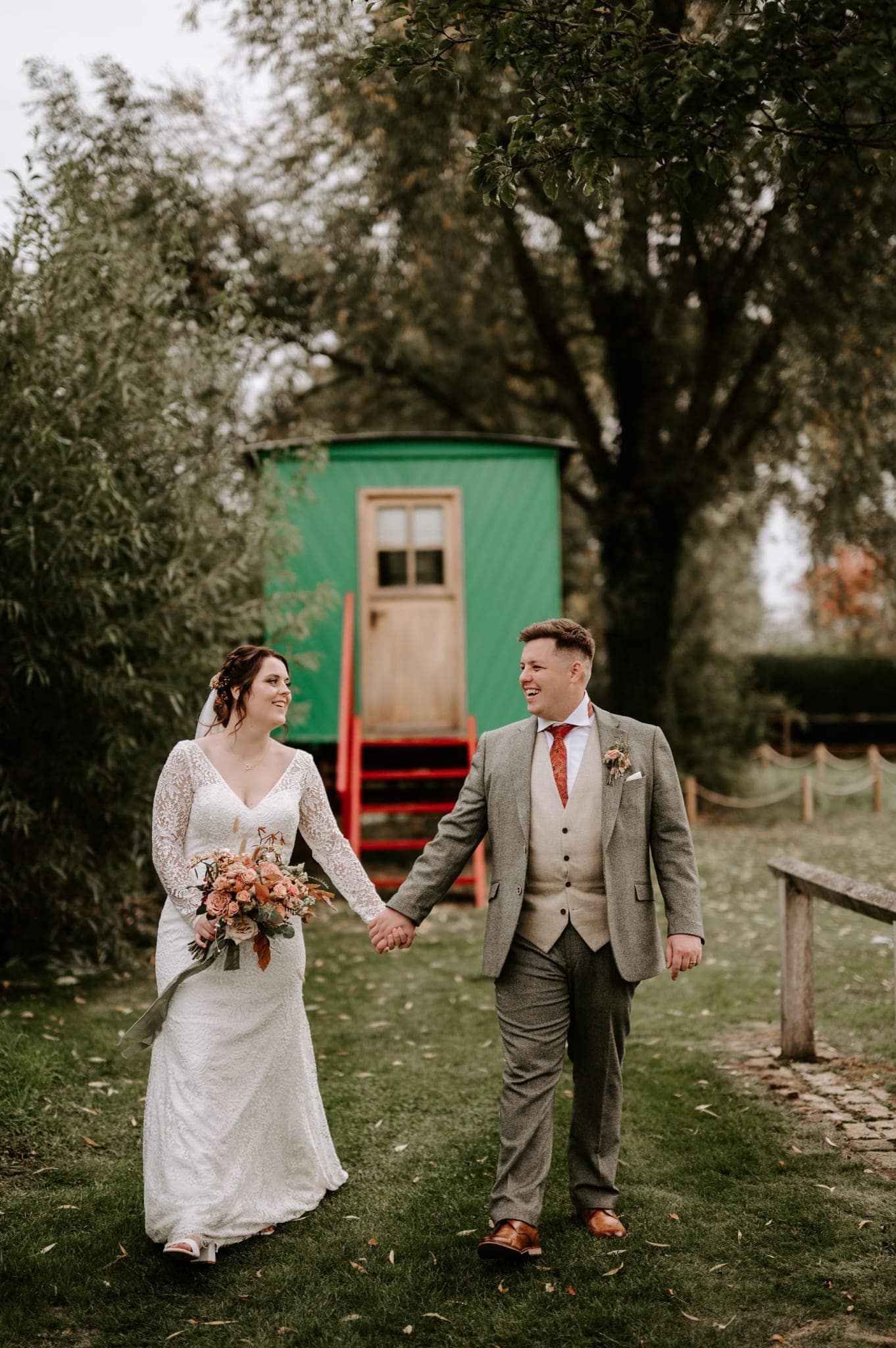Bride and Groom in front of unique green ploughmans wagon