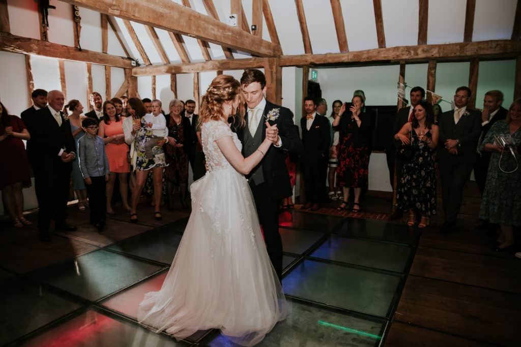 Bride and Groom enjoy their first dance at evening wedding reception in stunning barn wedding venue 