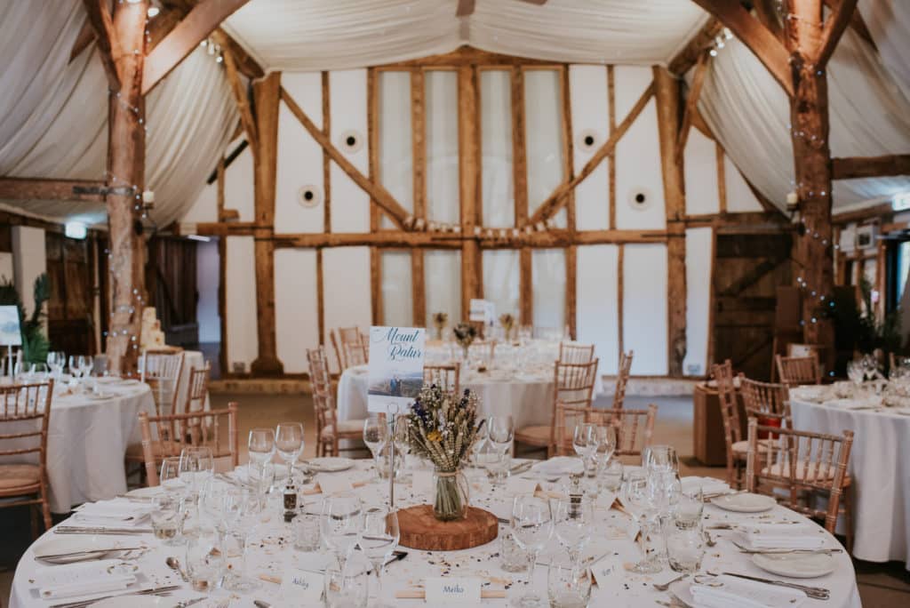 Rustic Barn Wedding Venue set for wedding breakfast with sustainable dried flowers 
