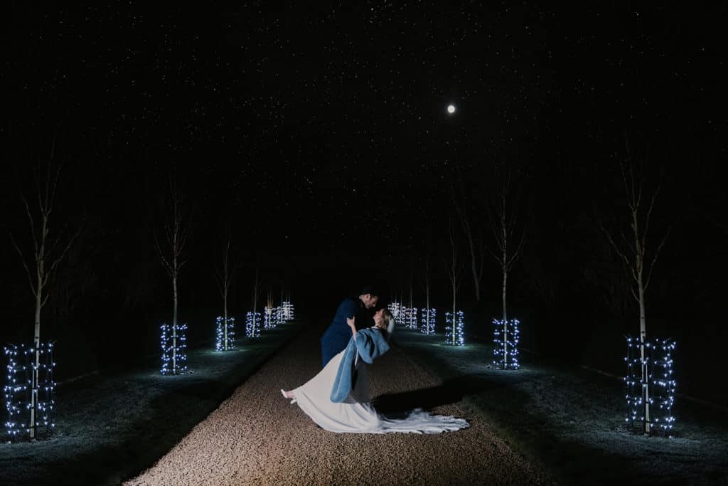 Winter Wedding at South Farm Bride and Groom on fairy lit driveway