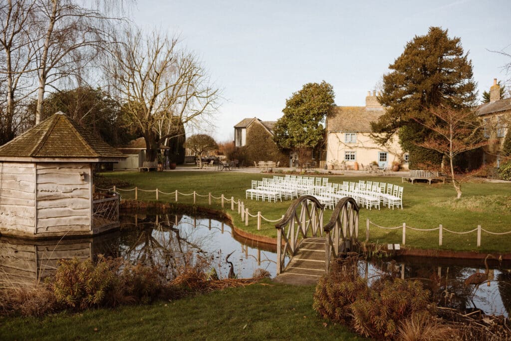 Garden Wedding Venue with pretty pond and cream farmhouse