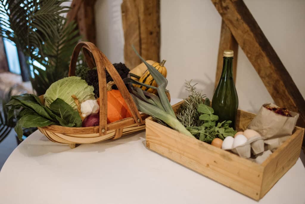 Home grown vegetables on display in trug and wooden box at South Farm Wedding Venue