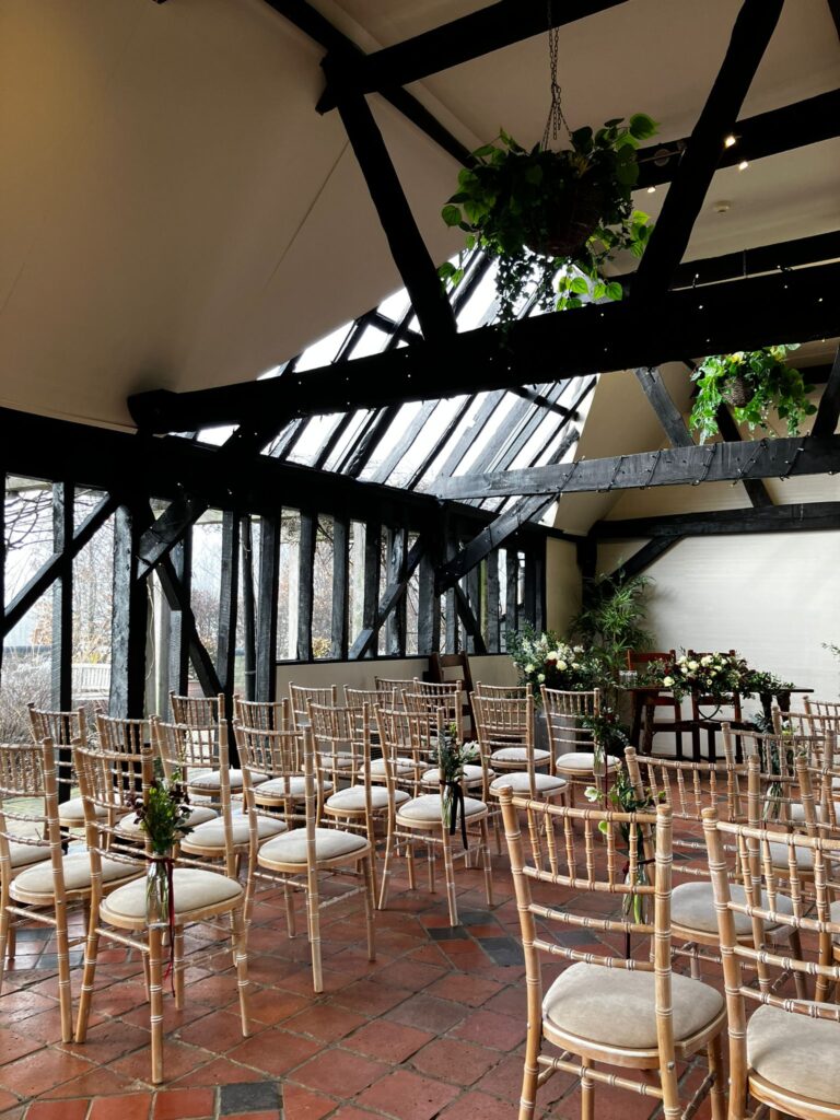 Wedding Ceremony at Rustic Bar ceremony with black timber beams and wedding floristry