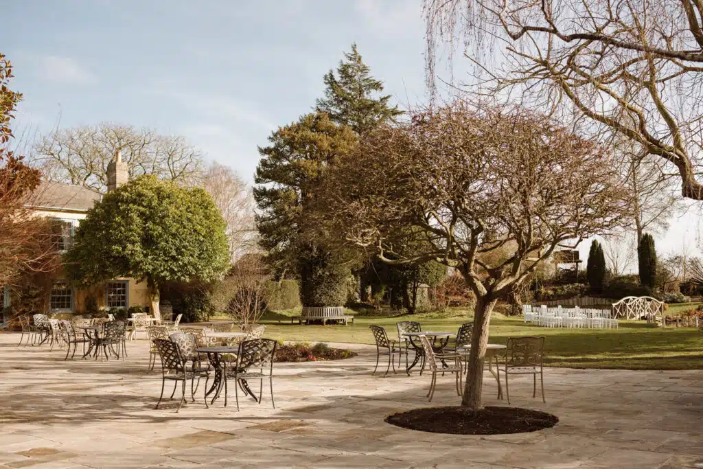 Sun terrace with trees and Garden chairs at garden wedding venue