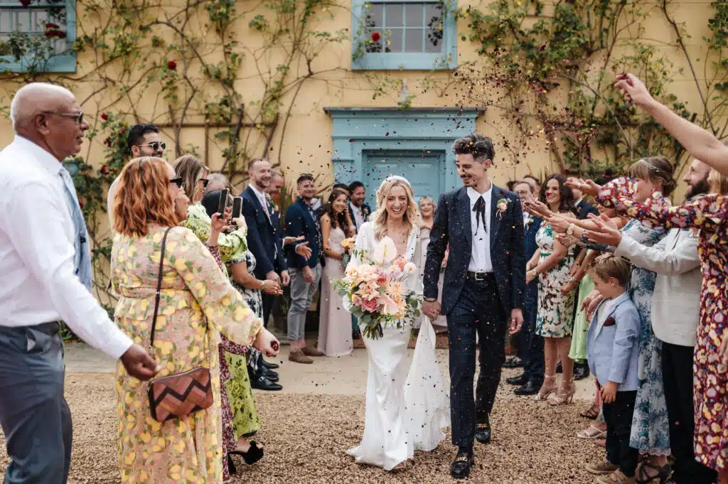 Bride and Groom have confetti shower at country house wedding venue