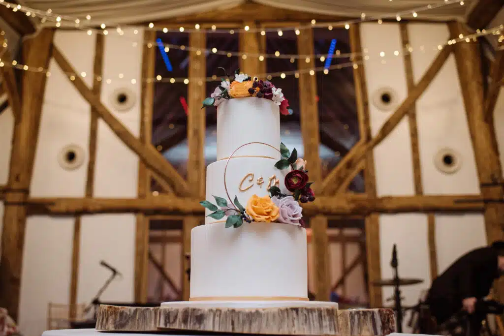 Winter Wedding Cake in barn wedding venue with twinkly fairylights