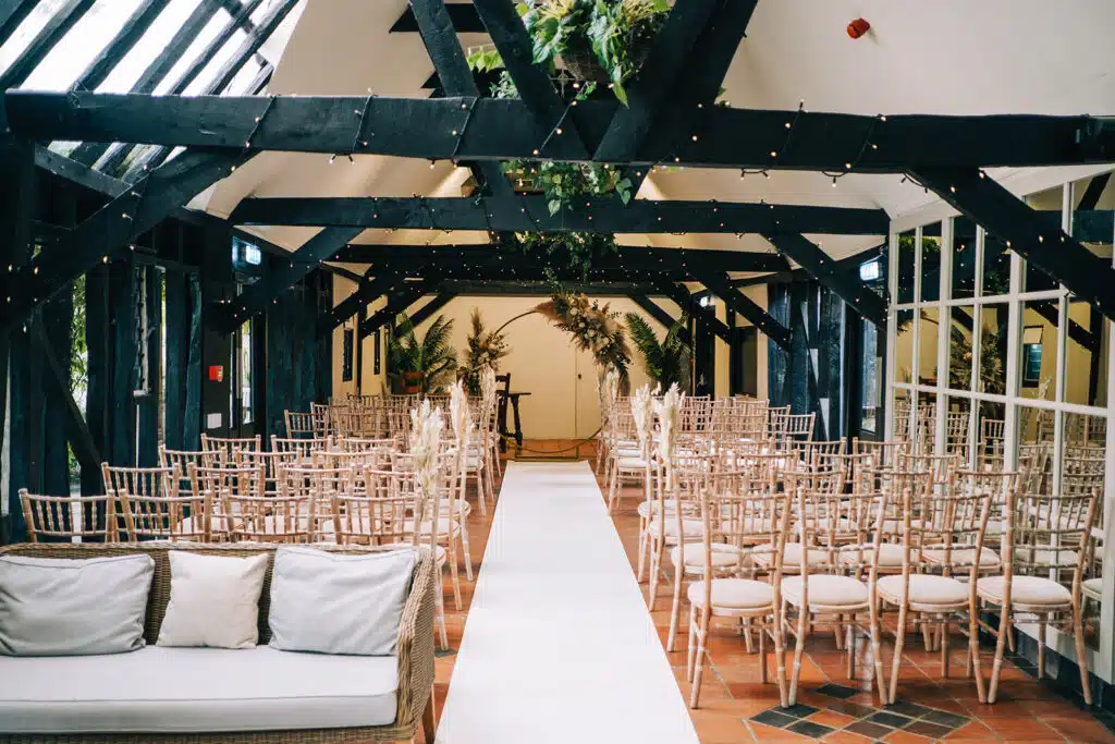 Barn Wedding Venue set for ceremony with white aisle carpet