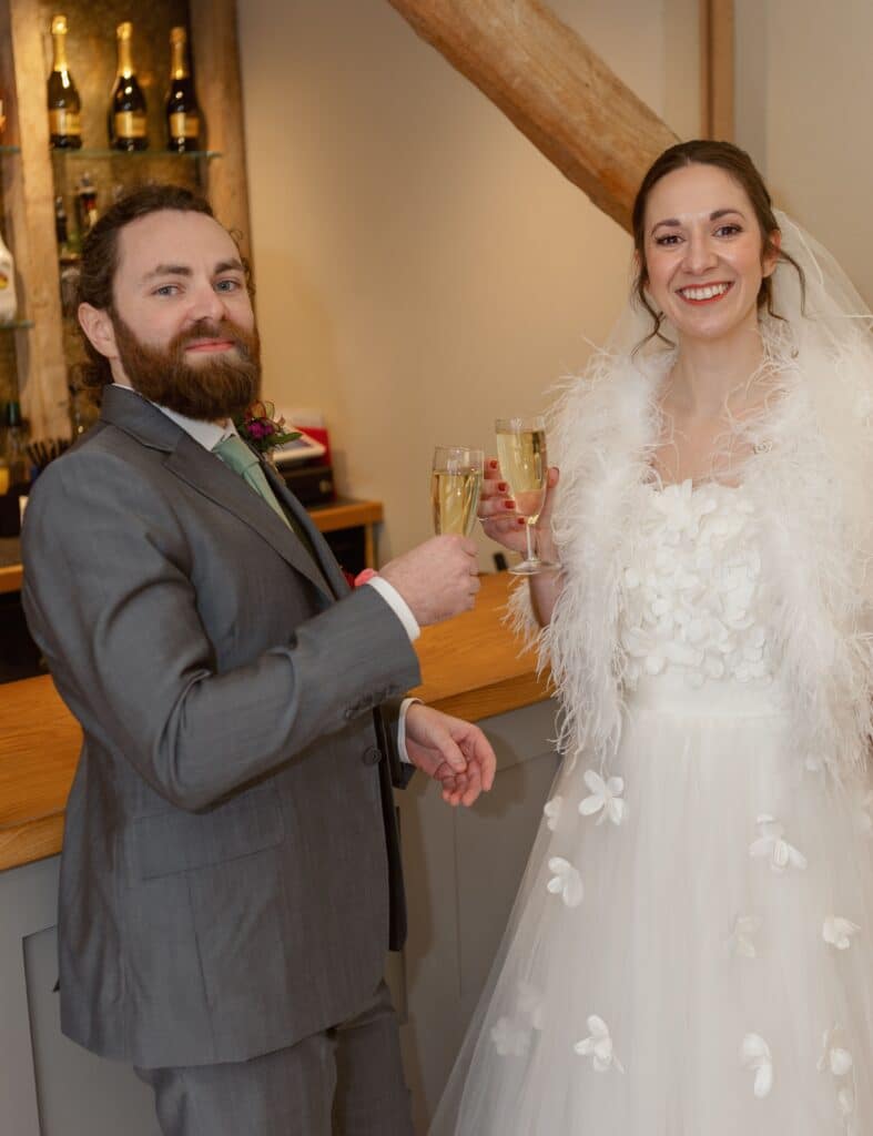Groom and bride raise a champagne toast on their wedding day