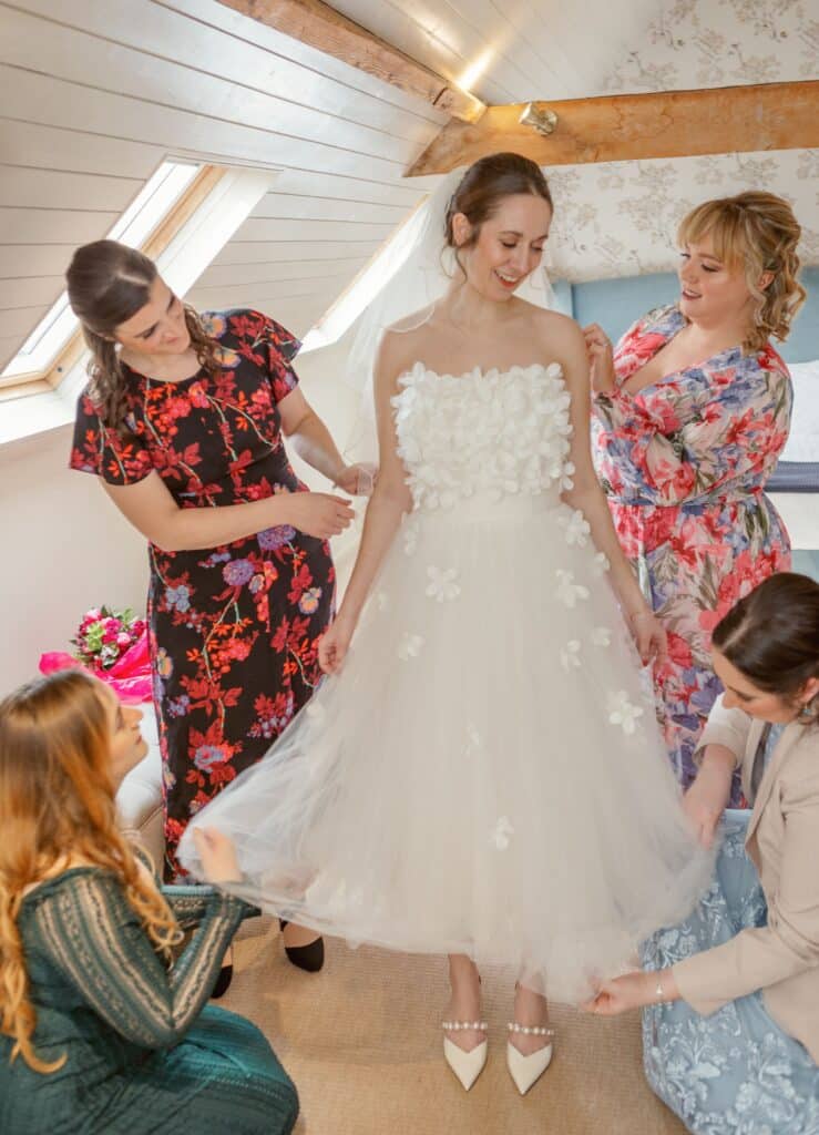 Bride and bridesmaids getting ready in country wedding venue 