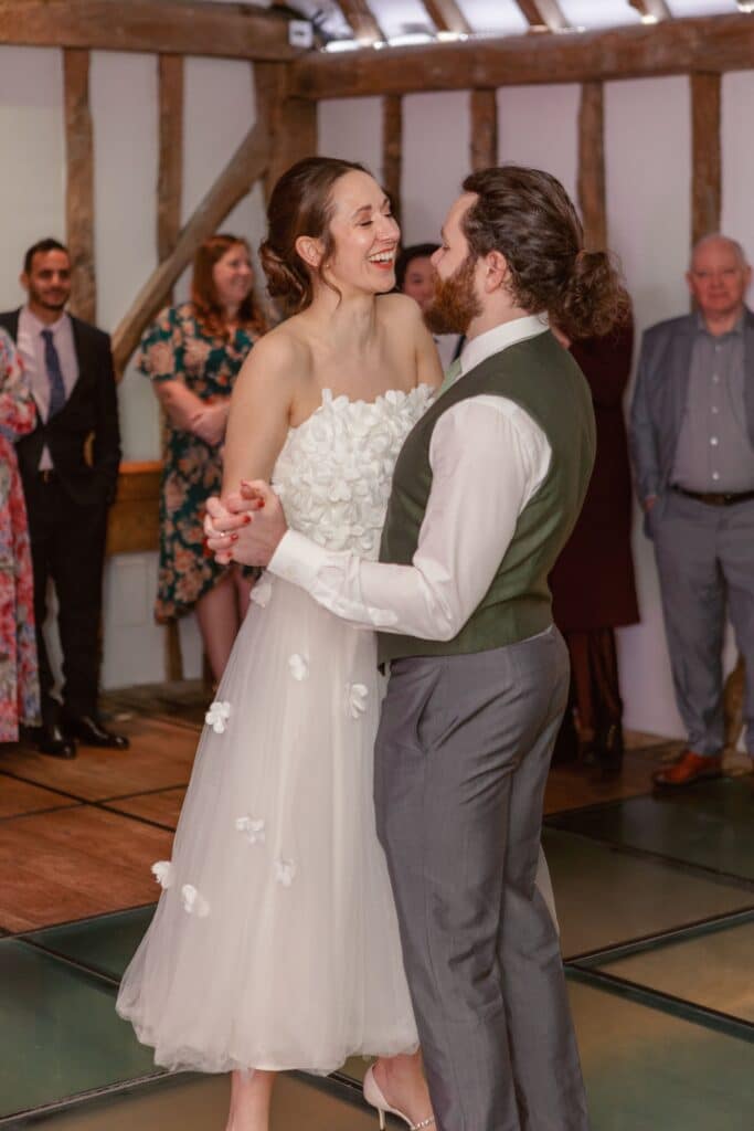 Bride and groom first dance at rustic barn wedding venue
