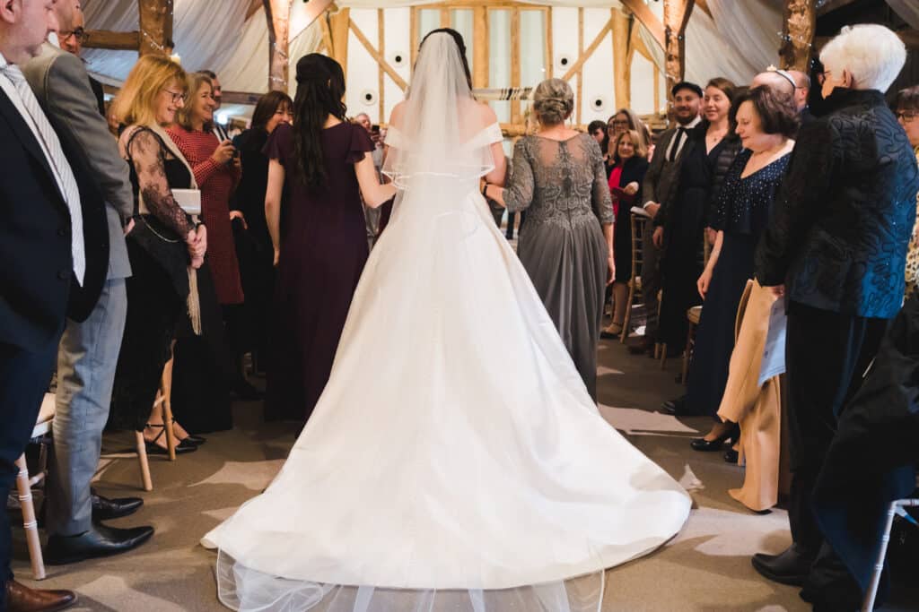 Bride at Jewish wedding walks down the aisle 