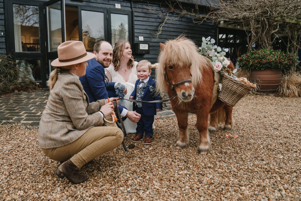 Bride and Groom at farm wedding venue with confetti pony
