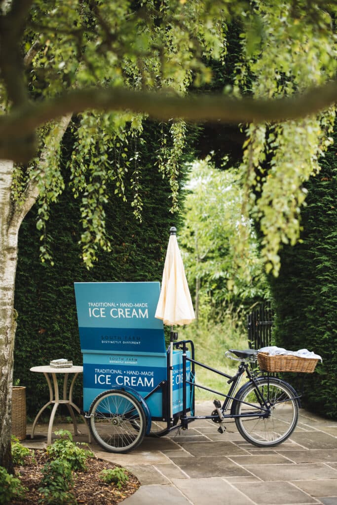 Ice cream bike under tree at garden wedding venue 