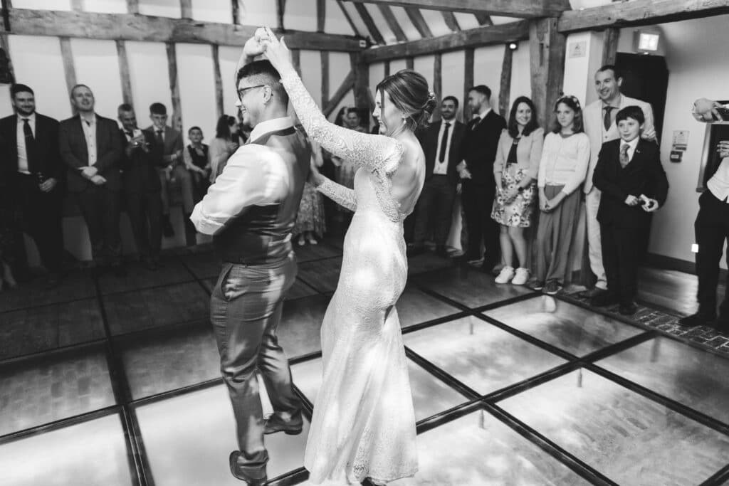 Black & White Photo of Bride and Groom during first dance in barn wedding venue