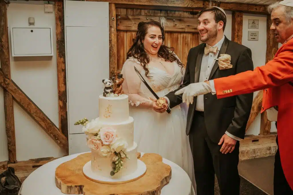 Bride and Groom at Jewish Wedding cutting their wedding cake