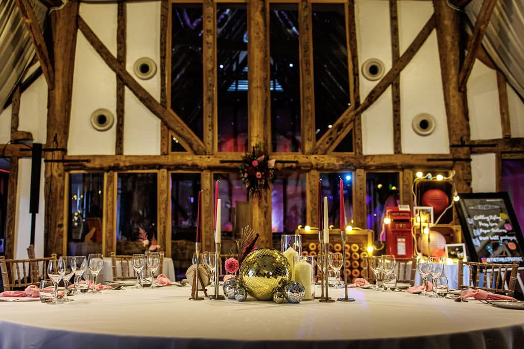 Tope Table at Barn Wedding Venue decorated wtih disco balls and candles