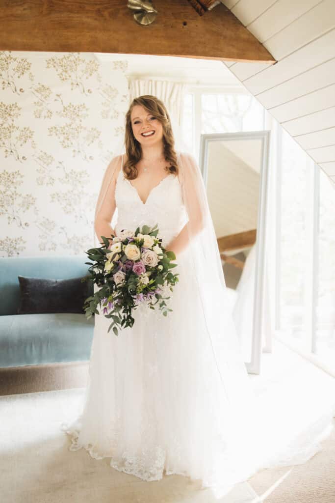 Beautiful bride ready in wedding dress in sunlight bridal suite 