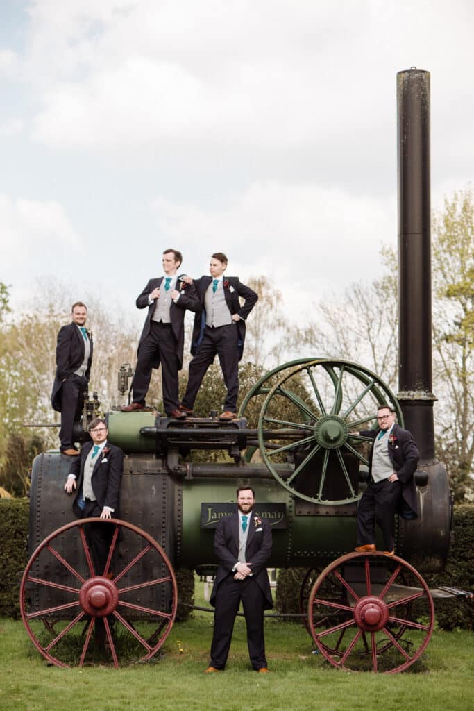 Groomsmen at wedding venue on rustic steam engine