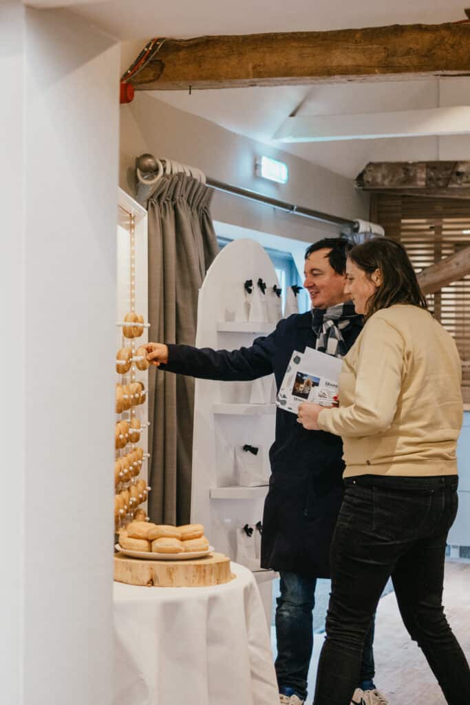 Guests look at doughnut wall at wedding venue open day