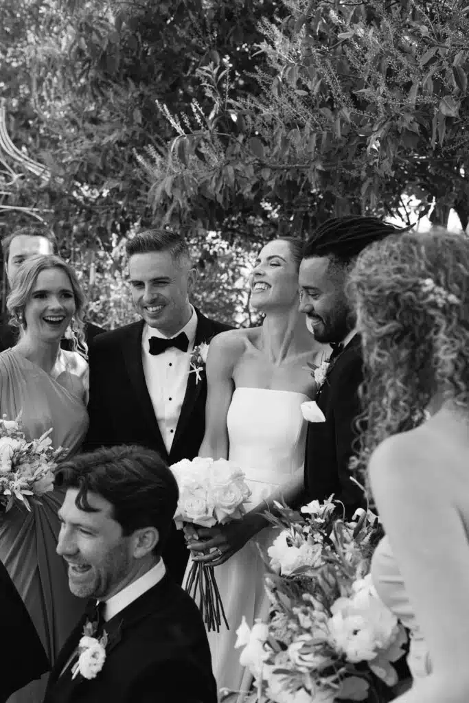 Bride, groom and their bridal having a special moment during the day at stunning countryside wedding venue