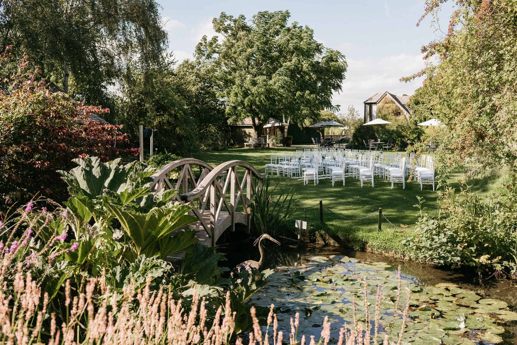 Beautiful Garden set for wedding with white ceremony chairs