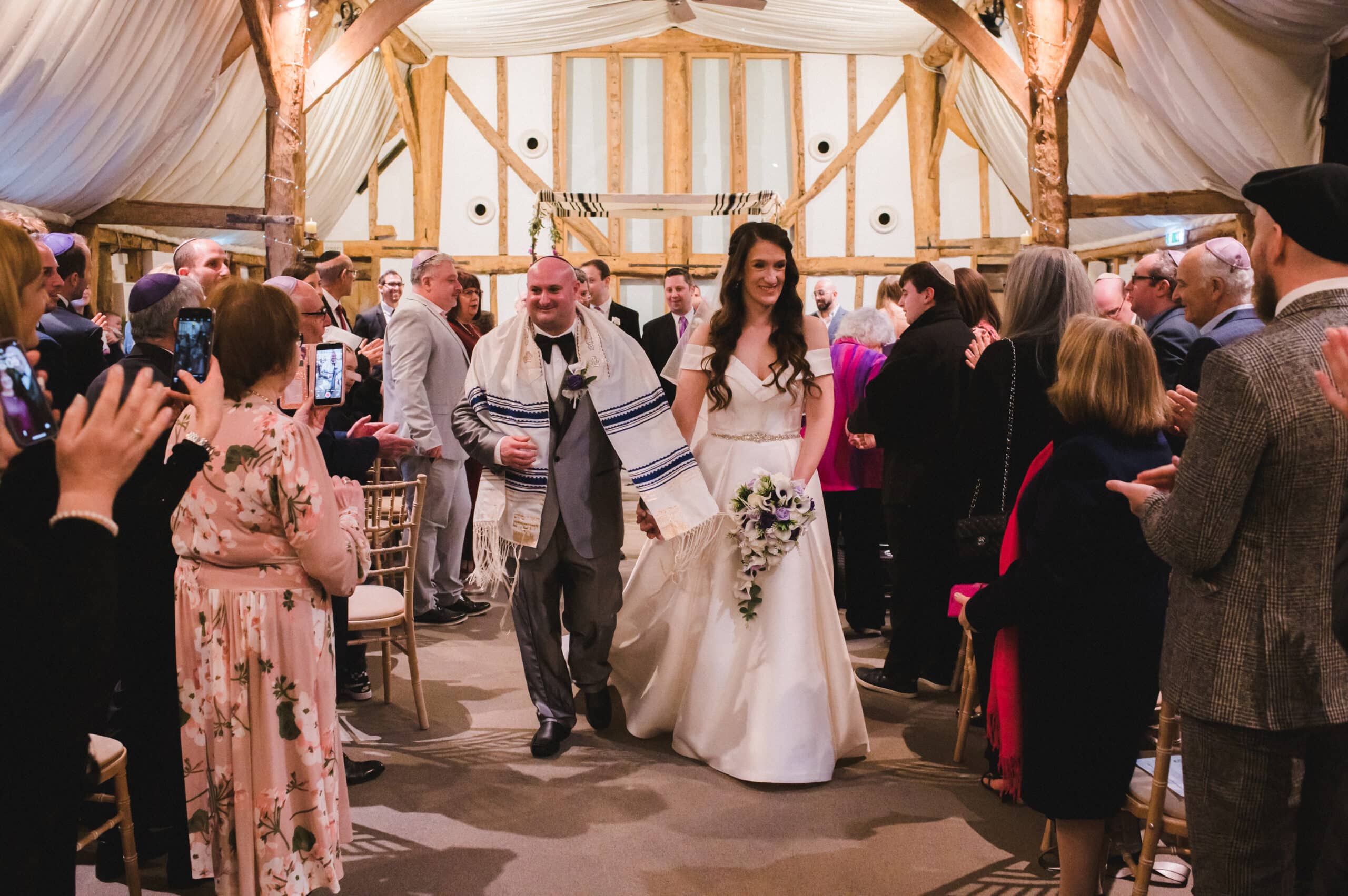 Bride and Groom just married exit aisle of wedding ceremony in Jewish barn wedding venue