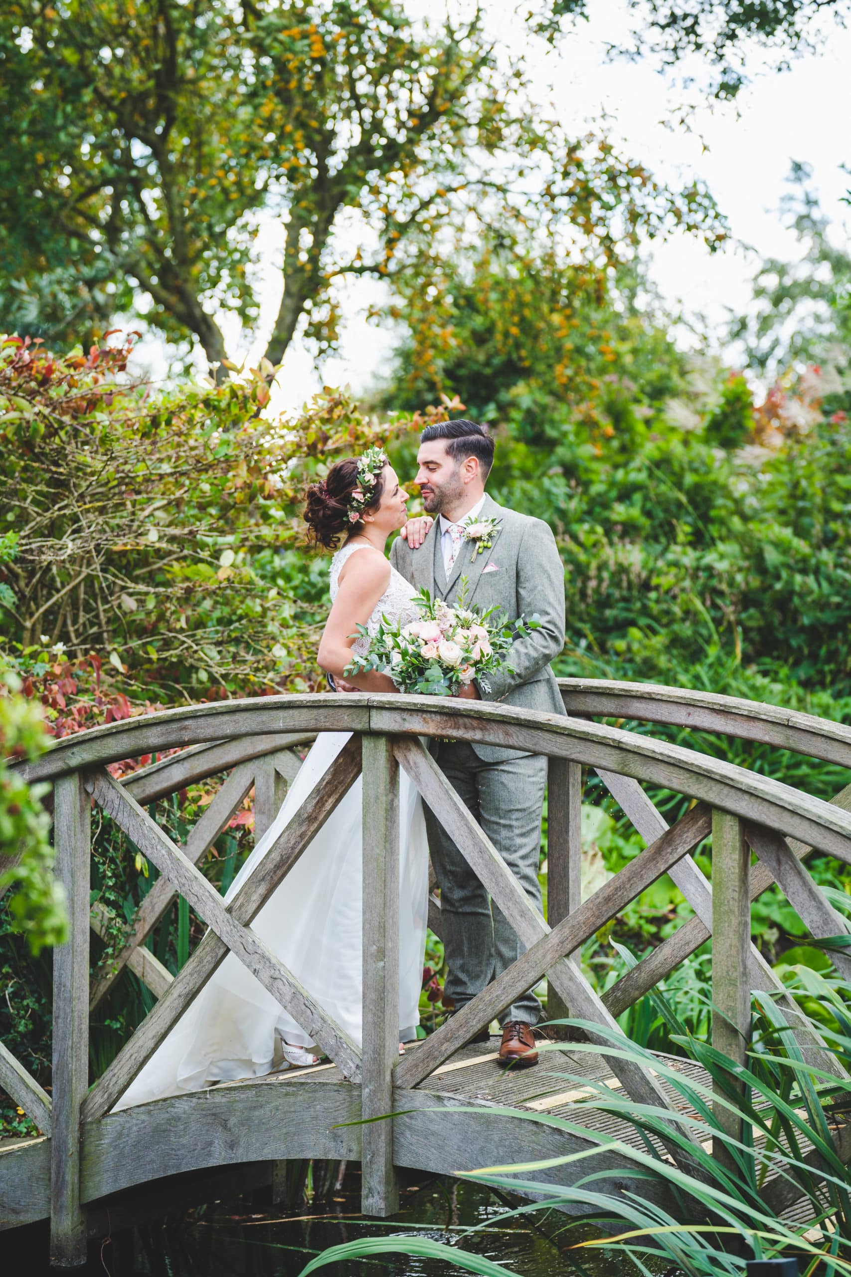 Bride & Groom on Monet Bridge in Pretty Autumn Garden at Cambridgeshire Rustic Wedding Venue