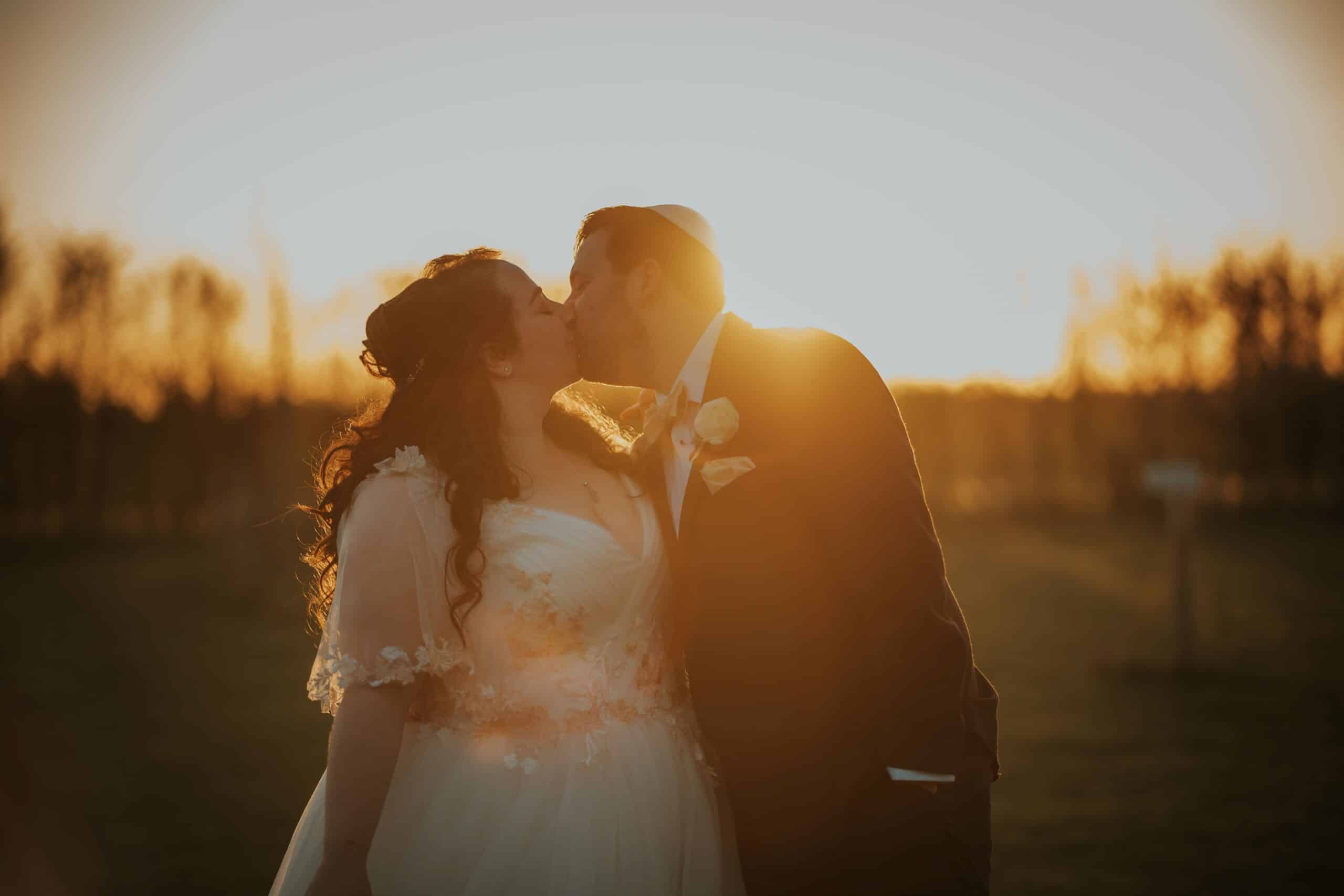 Bride and Groom kiss at sunset in the garden of their Jewish Wedding Venue