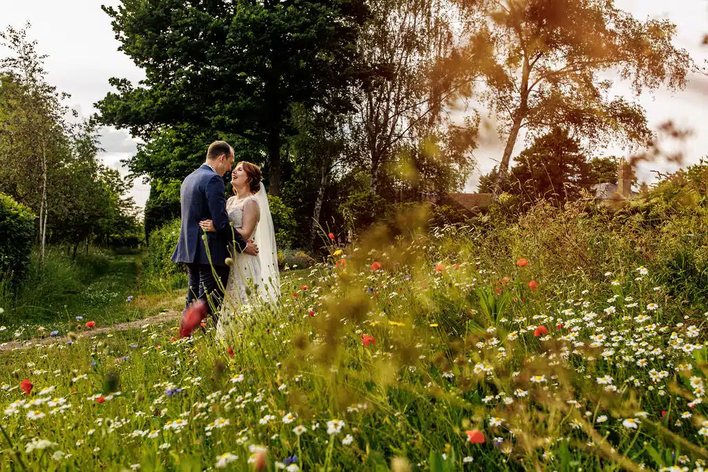 Photo of couple in beautiful summer wedding garden on wedding day