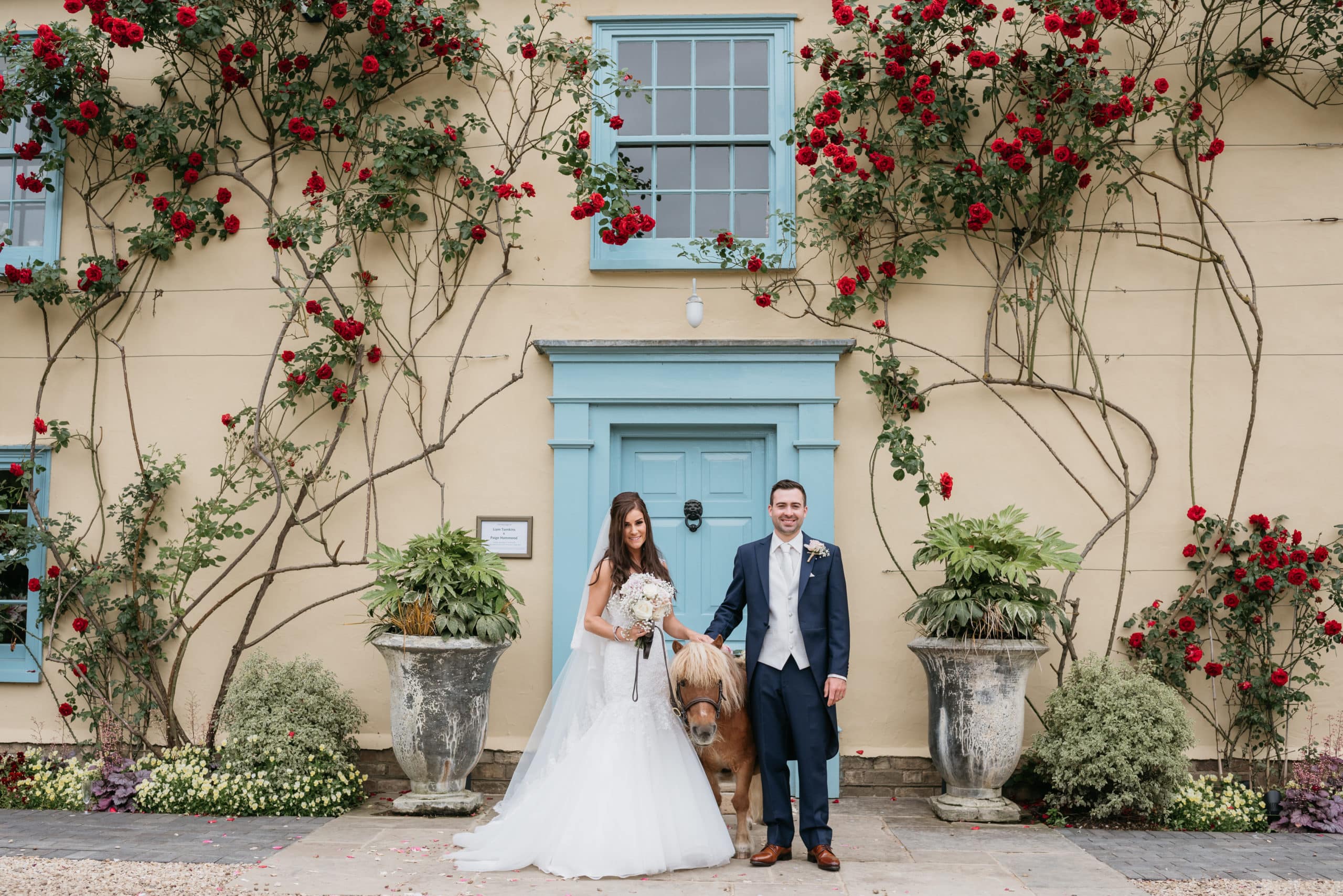 Bride and Groom with Confetti Pony at Rustic Farm Wedding Venue