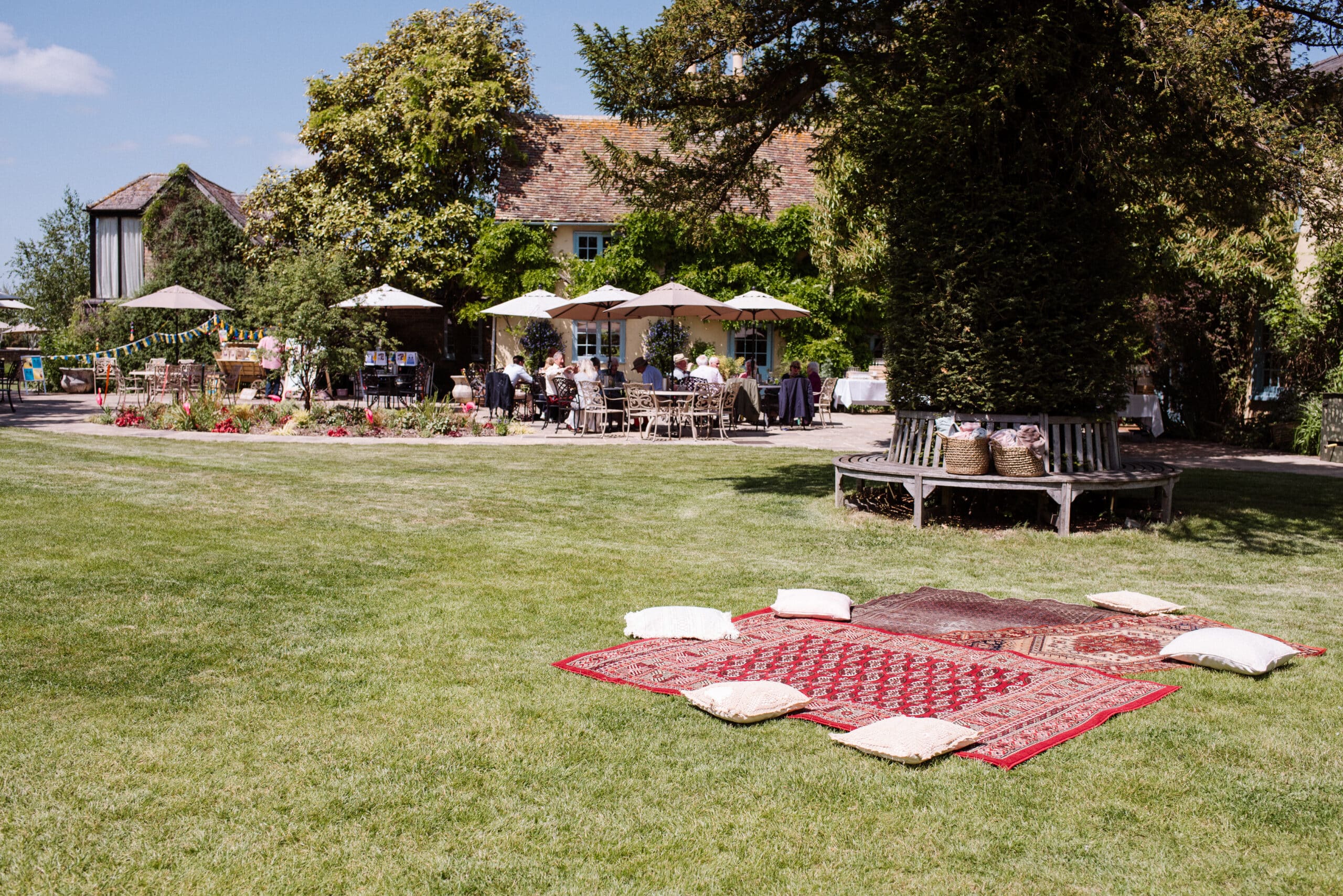 Colourful Rugs in garden on summers day at countryside wedding venue charity event