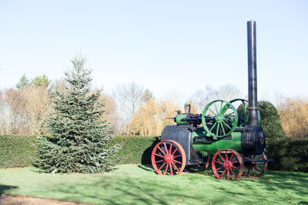 Christmas tree next to vintage steam engine on a sunny day