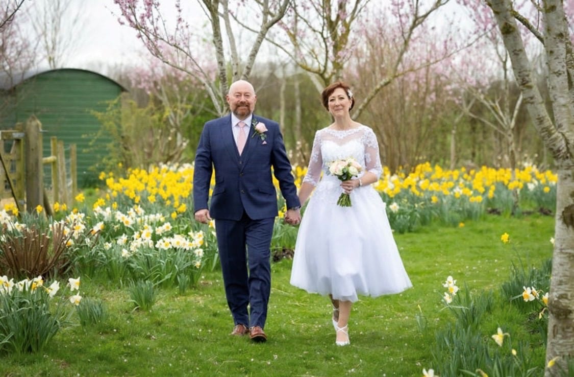 Bride and Groom at Garden Wedding Venue in a field of yellow daffodils