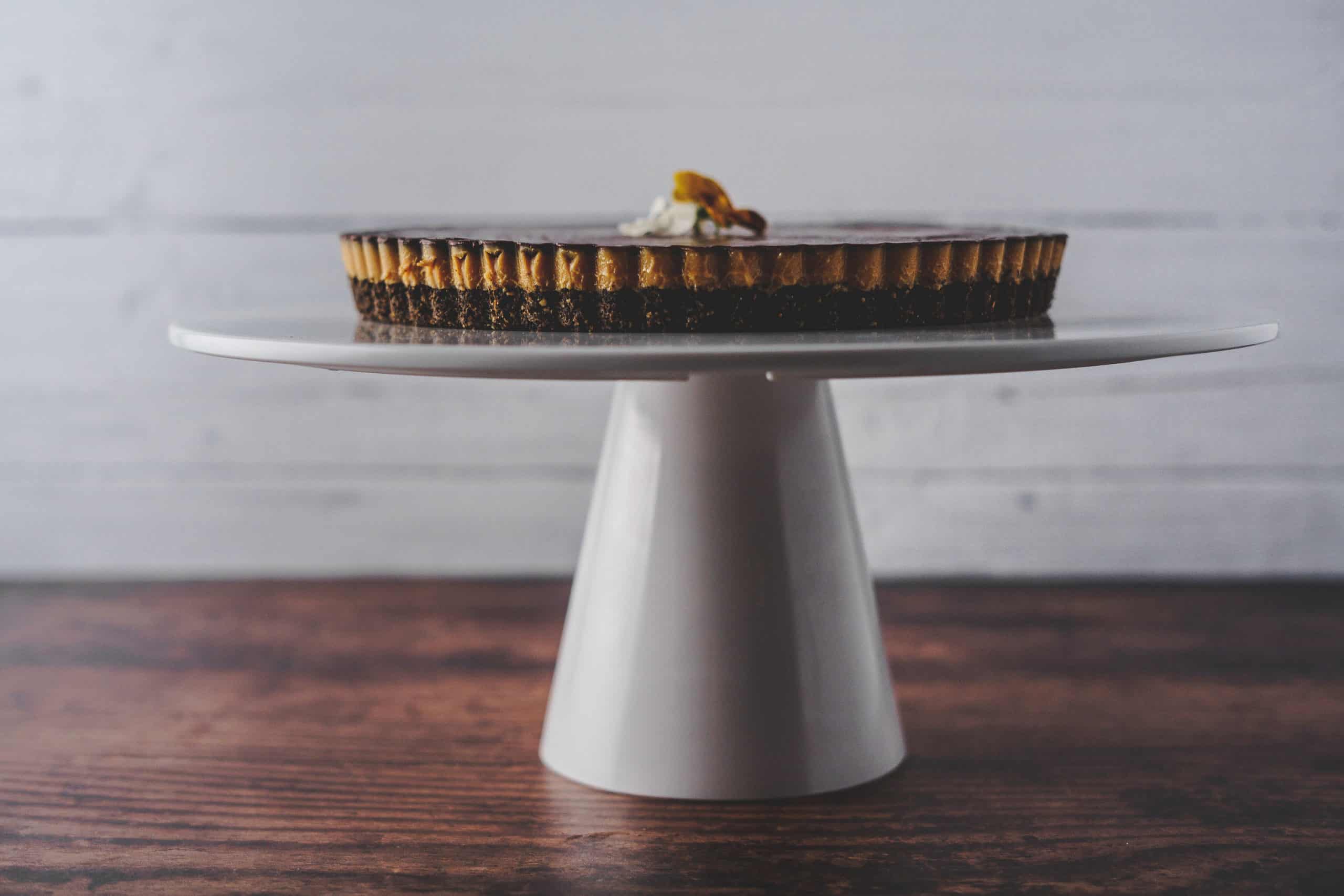 Chocolate torte on tall white cake stand