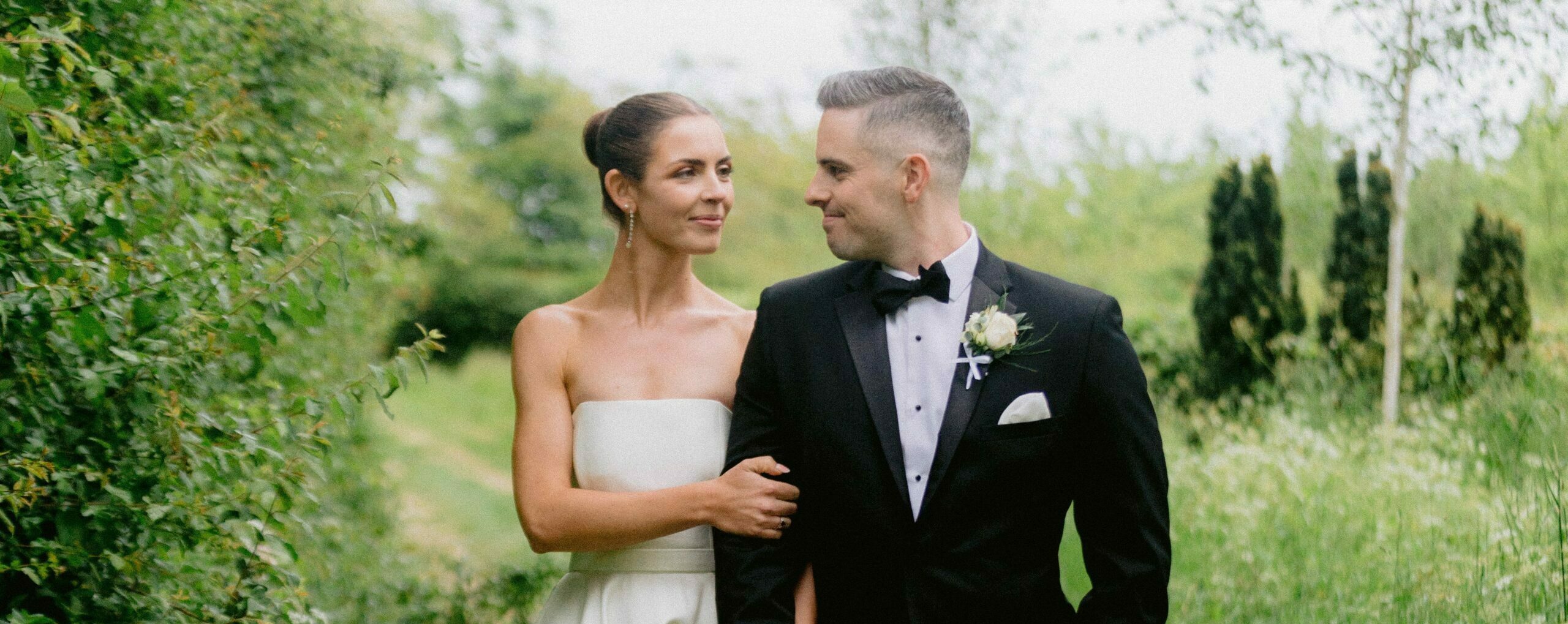 Photo of bride and groom on wedding day in garden of countryside wedding venue